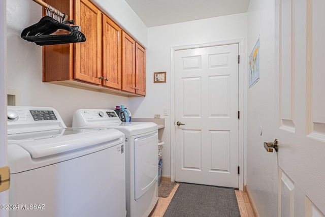 laundry room featuring cabinets and separate washer and dryer