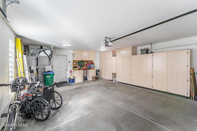 garage with ceiling fan, gas water heater, and a garage door opener