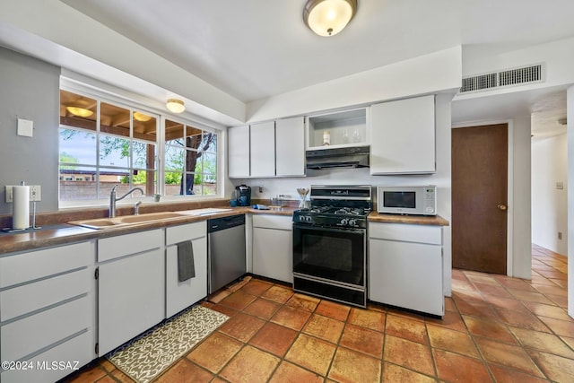 kitchen featuring stainless steel dishwasher, black range with gas cooktop, sink, and white cabinets