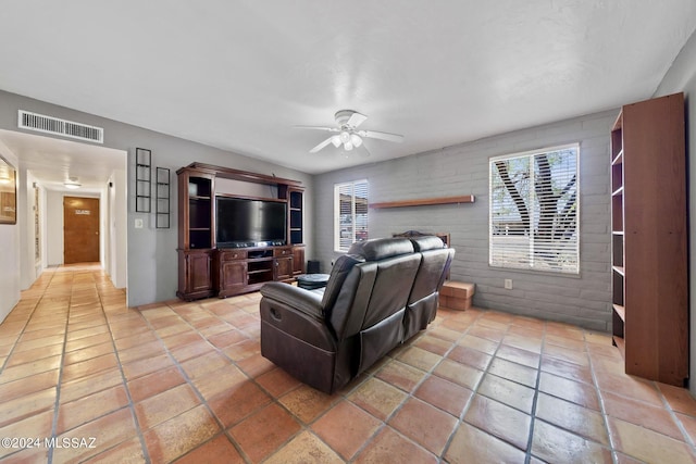 living room with ceiling fan and a healthy amount of sunlight