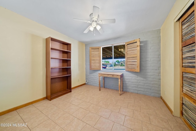 unfurnished living room with built in shelves, ceiling fan, and light tile patterned floors