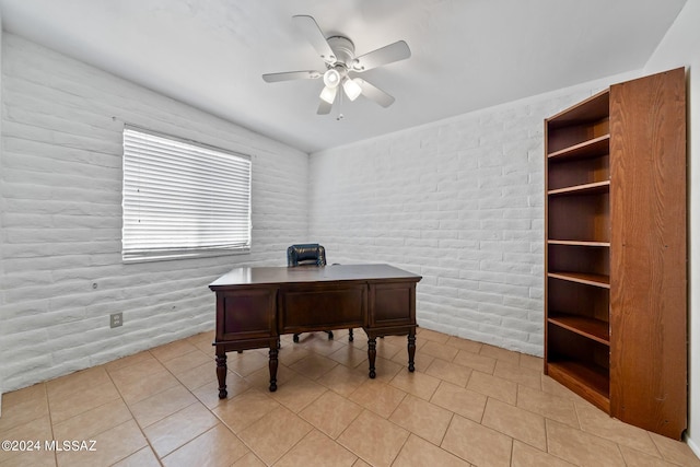 tiled home office with brick wall and ceiling fan