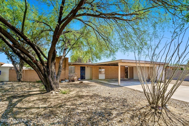 rear view of property with a carport