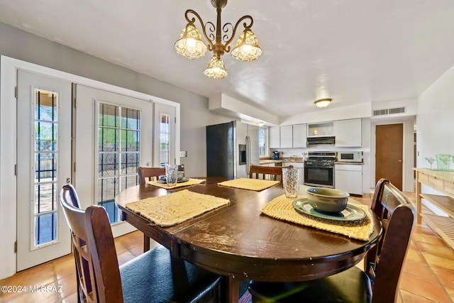 dining room featuring light tile patterned flooring and a notable chandelier