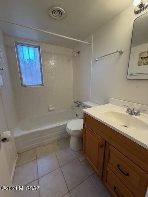 full bathroom with tile patterned floors, toilet, vanity, and tiled shower / bath