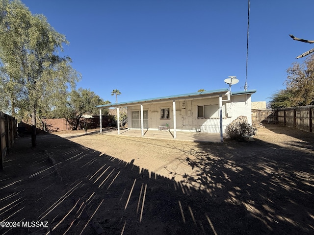 rear view of property featuring a patio area