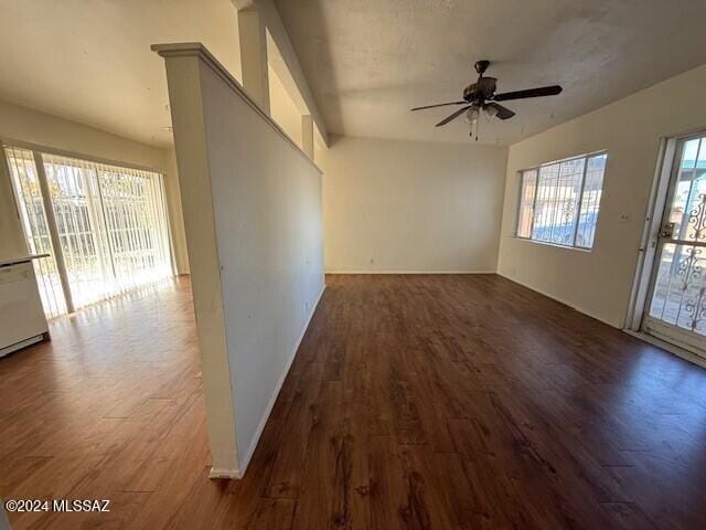 interior space featuring a wealth of natural light, dark wood-type flooring, and ceiling fan