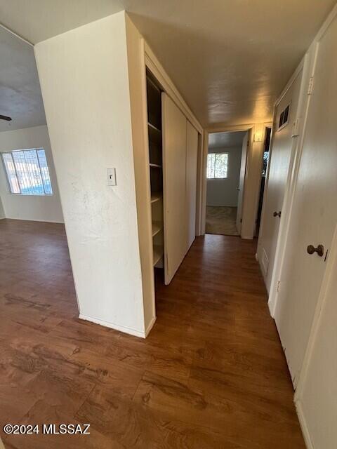 corridor featuring dark hardwood / wood-style flooring