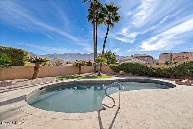 view of pool with a patio and a mountain view