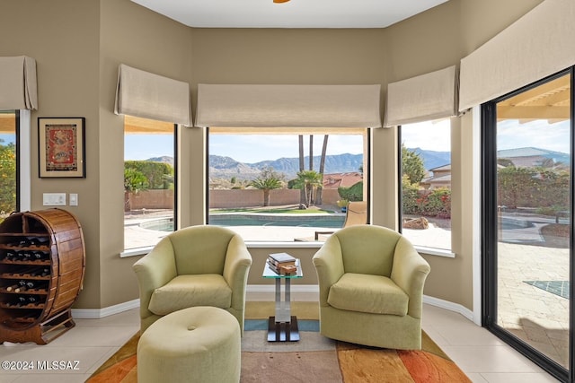 living area featuring a mountain view and light tile patterned floors