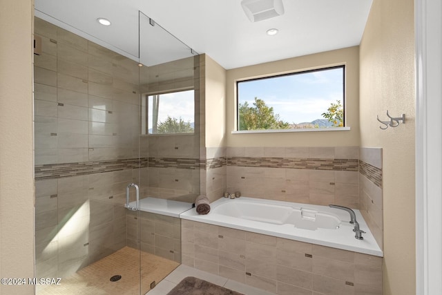 bathroom featuring tile patterned floors and separate shower and tub