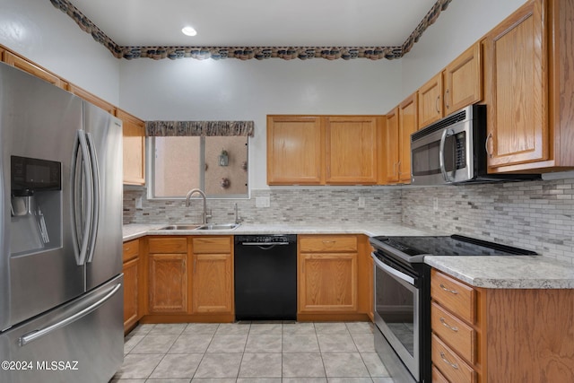 kitchen with backsplash, sink, light tile patterned flooring, and appliances with stainless steel finishes