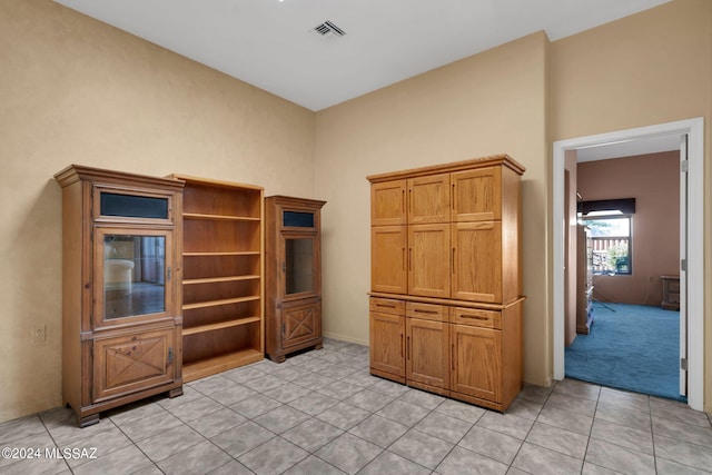 unfurnished office featuring light tile patterned flooring