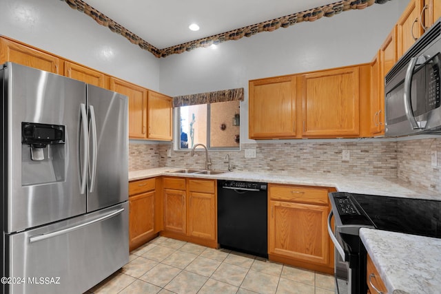 kitchen with tasteful backsplash, sink, light tile patterned floors, and black appliances