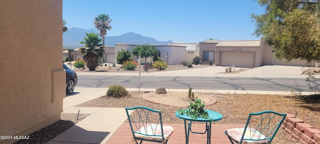 view of yard with a mountain view and a garage