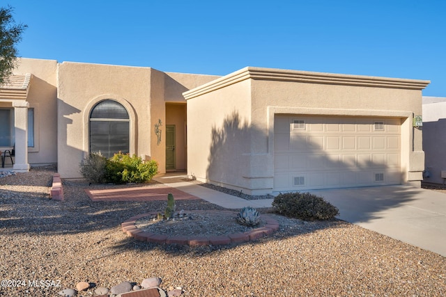 southwest-style home featuring a garage