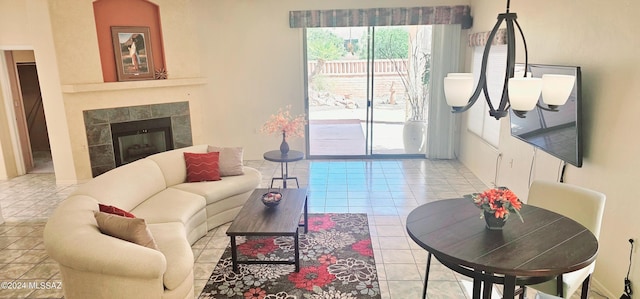 living room with a tile fireplace and light tile patterned floors