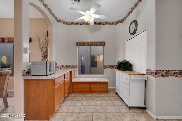 kitchen featuring ceiling fan and light tile patterned flooring