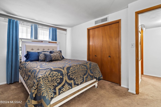 bedroom with carpet flooring and a closet