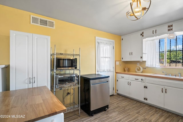 kitchen featuring light hardwood / wood-style flooring, white cabinetry, and sink