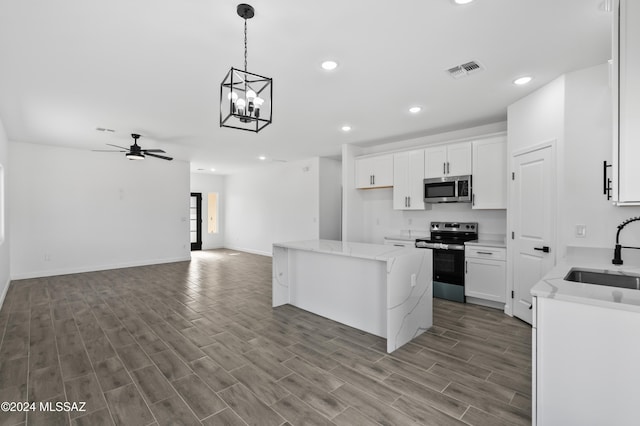 kitchen featuring hardwood / wood-style flooring, sink, white cabinets, and appliances with stainless steel finishes