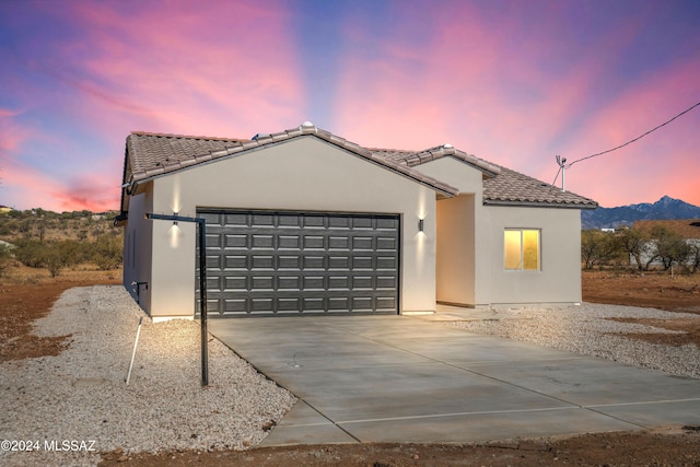 view of front of home with a mountain view and a garage