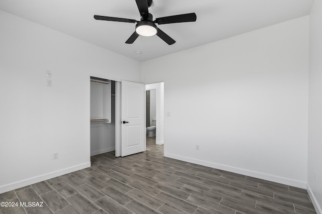 unfurnished bedroom featuring ceiling fan, a closet, and dark hardwood / wood-style floors