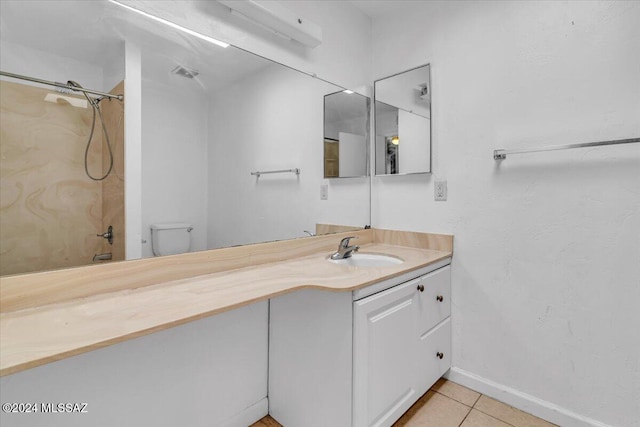 full bathroom featuring tile patterned floors, vanity, toilet, and washtub / shower combination