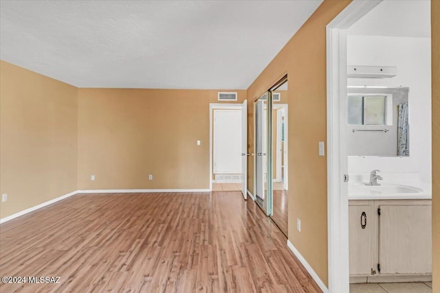 interior space featuring light wood-type flooring and sink