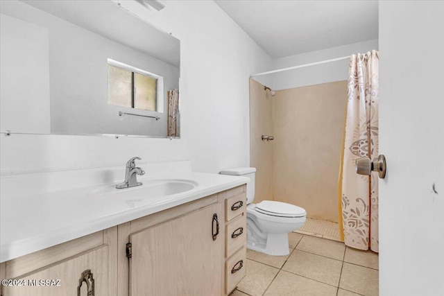 bathroom with toilet, vanity, tile patterned floors, and a shower with shower curtain