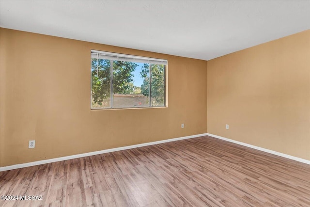 spare room with light hardwood / wood-style flooring