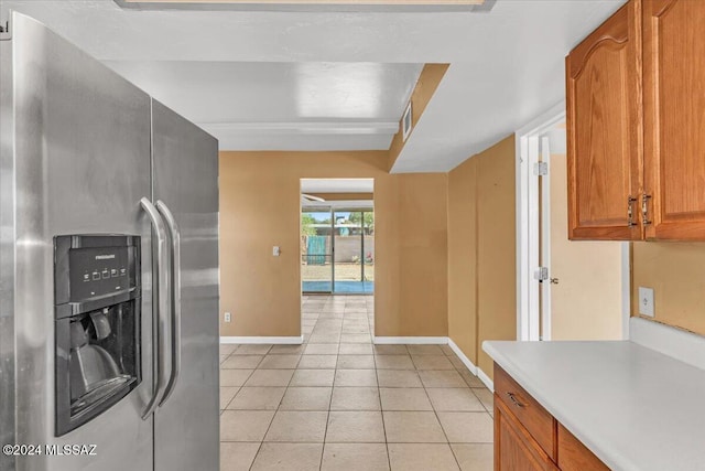 kitchen featuring stainless steel fridge with ice dispenser and light tile patterned floors