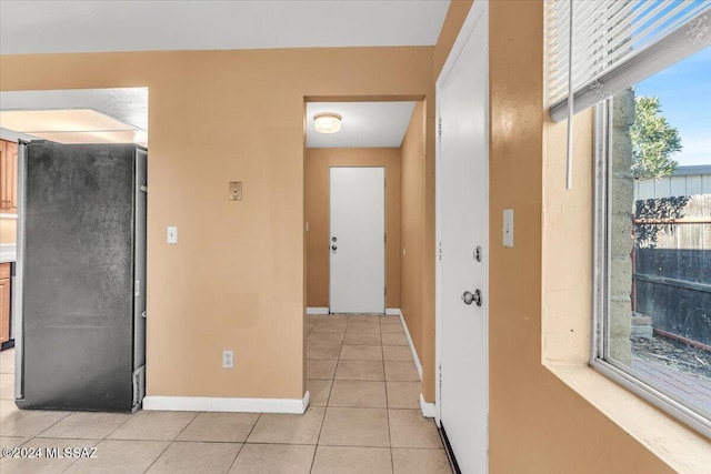 hall featuring light tile patterned floors