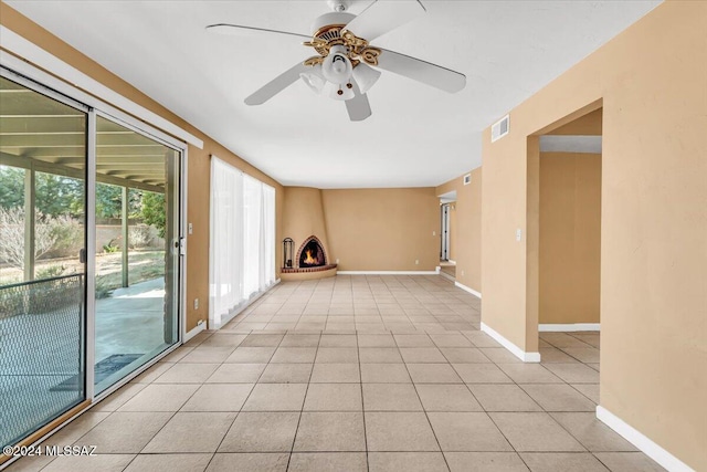 unfurnished room featuring ceiling fan and light tile patterned floors