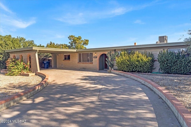 ranch-style home featuring a carport