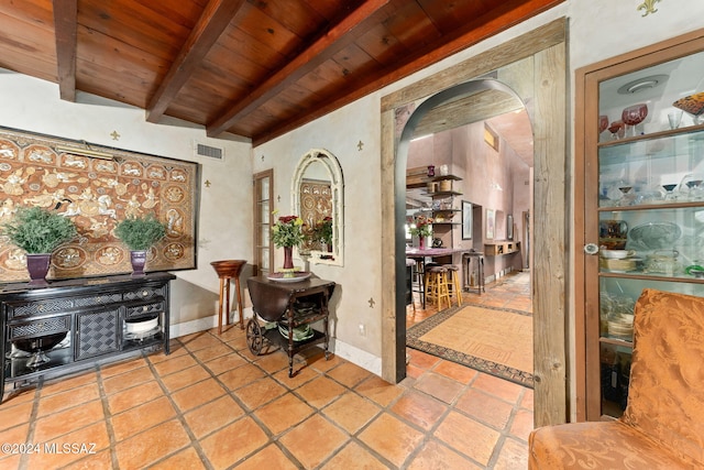 interior space with beamed ceiling and wooden ceiling