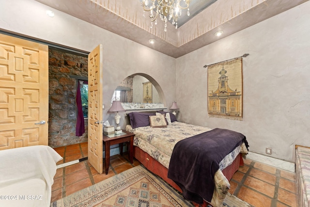 bedroom featuring tile patterned flooring and a chandelier