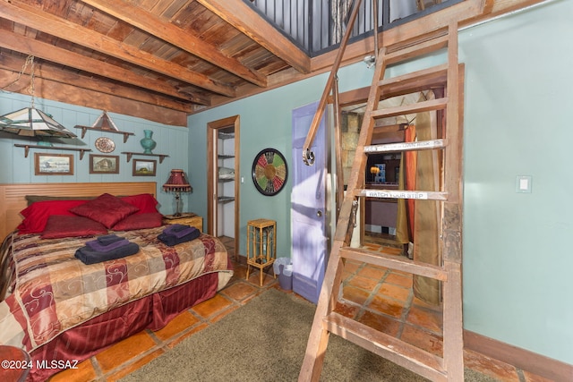 bedroom featuring beamed ceiling and wood ceiling