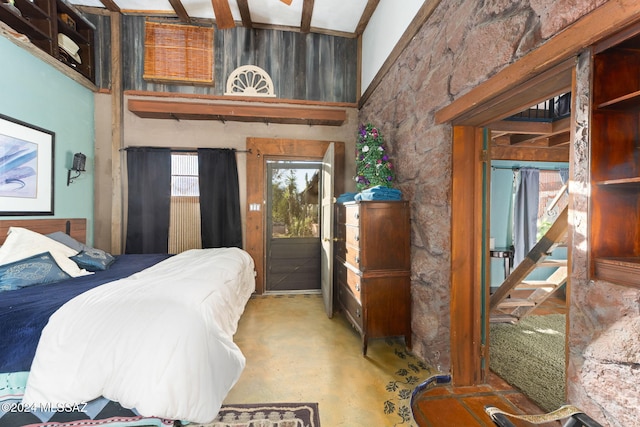 bedroom with beam ceiling and high vaulted ceiling