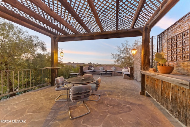 patio terrace at dusk featuring a pergola