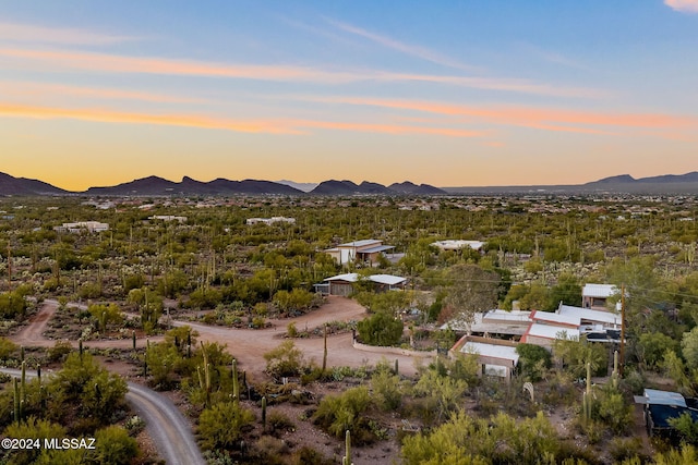 aerial view at dusk featuring a mountain view