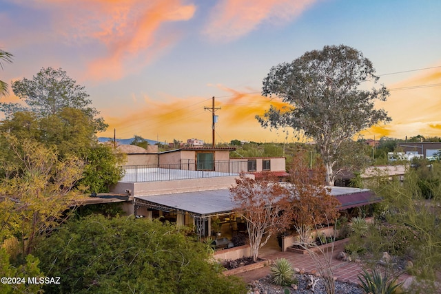 view of back house at dusk