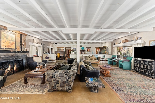 living room featuring beam ceiling and a high end fireplace