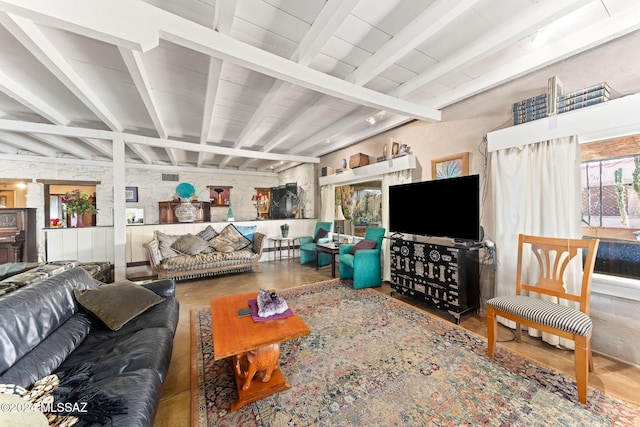 living room featuring beamed ceiling and wood-type flooring