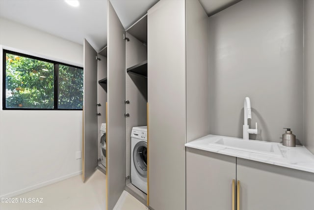 washroom featuring washer / clothes dryer and sink