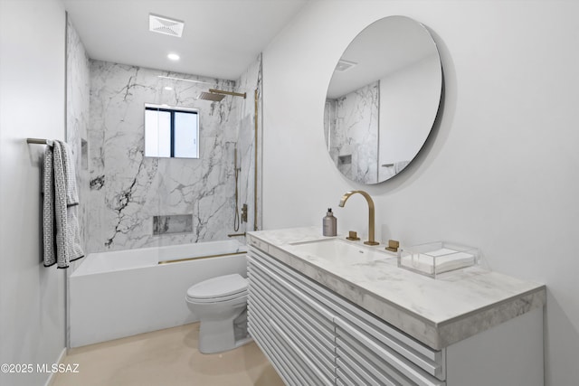 full bathroom with vanity, tiled shower / bath combo, and toilet