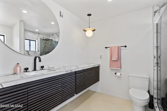 bathroom featuring walk in shower, vanity, and toilet