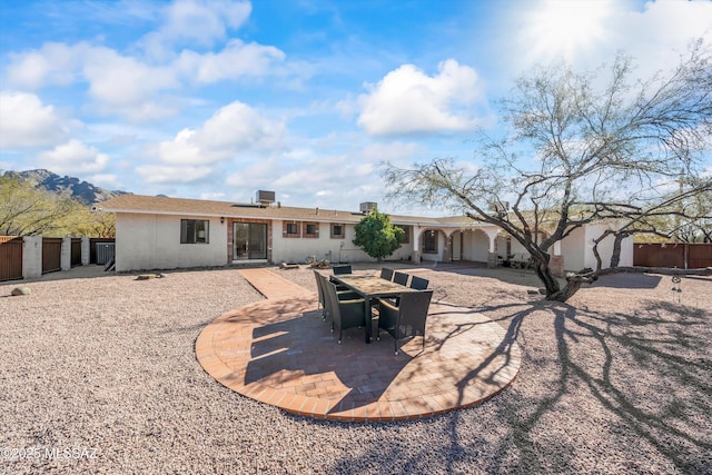 back of house featuring a mountain view and a patio area