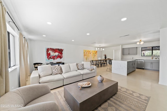 living room featuring sink and a notable chandelier