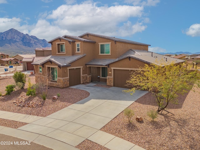 view of front of property with a mountain view and a garage